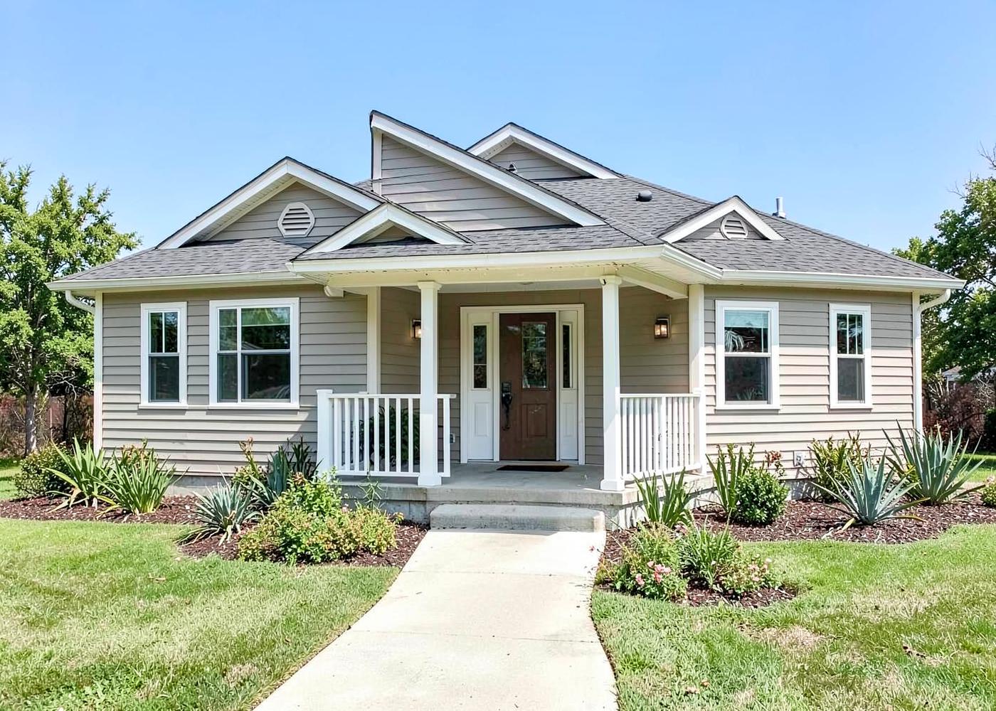 Updated front exterior of a single-story home with new porch and siding