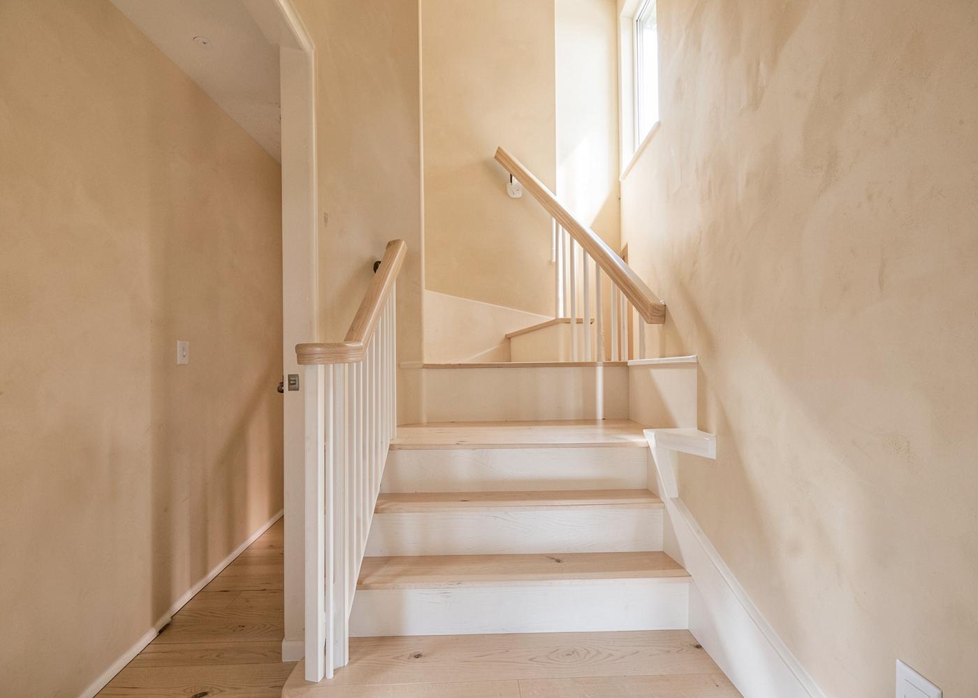 Renovated entry hall and staircase with white oak treads